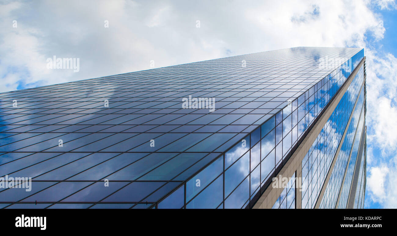 Modern glass office building against a blue cloudy sky Stock Photo - Alamy