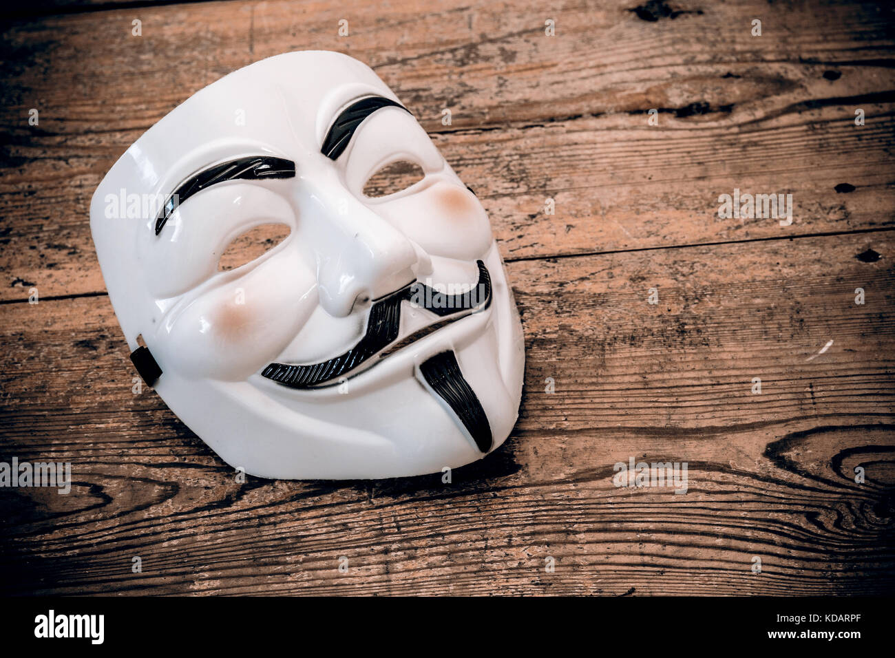 white anonymous mask on wood background - retro style Stock Photo - Alamy