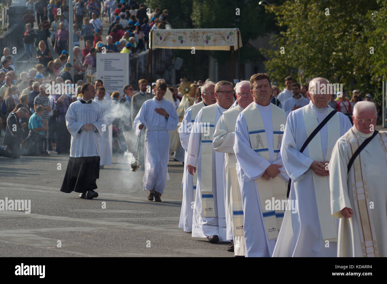 Procession of pilgrims and clergy at Lourdes, France Stock Photo