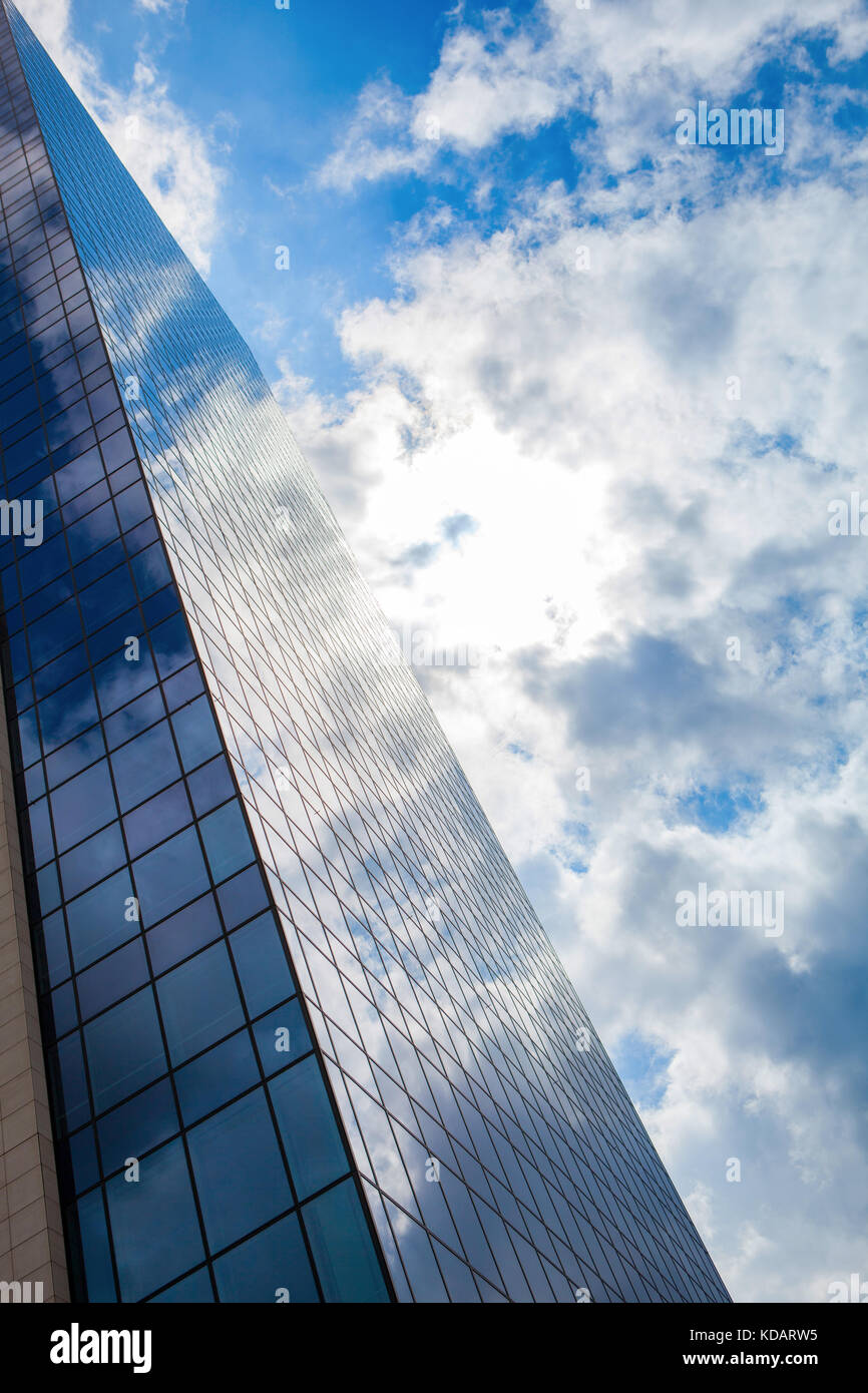 Modern smoked glass office building against a blue cloudy sky Stock ...