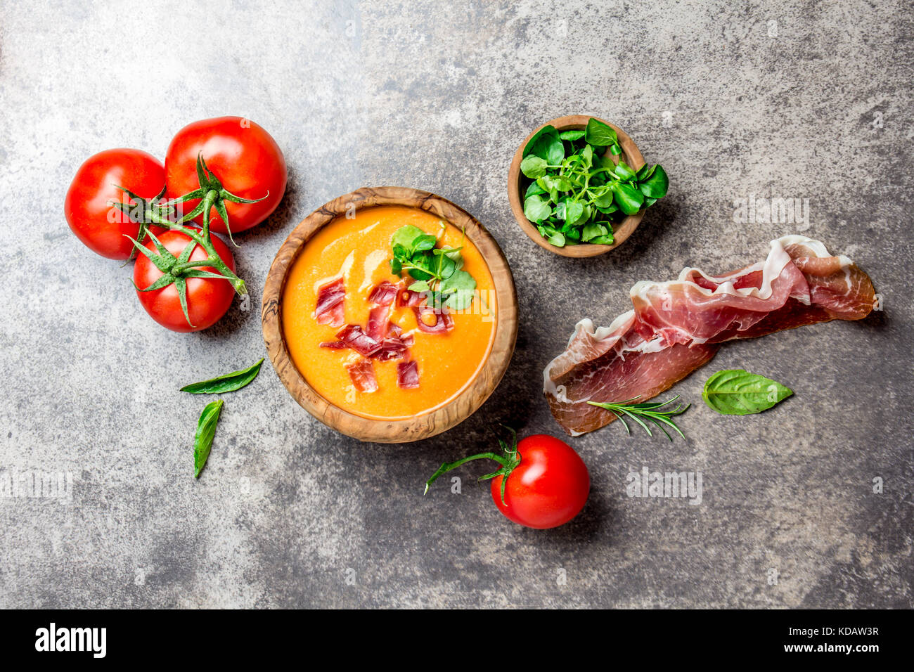 Spanish tomato soup Salmorejo served in olive wooden bowl with ham