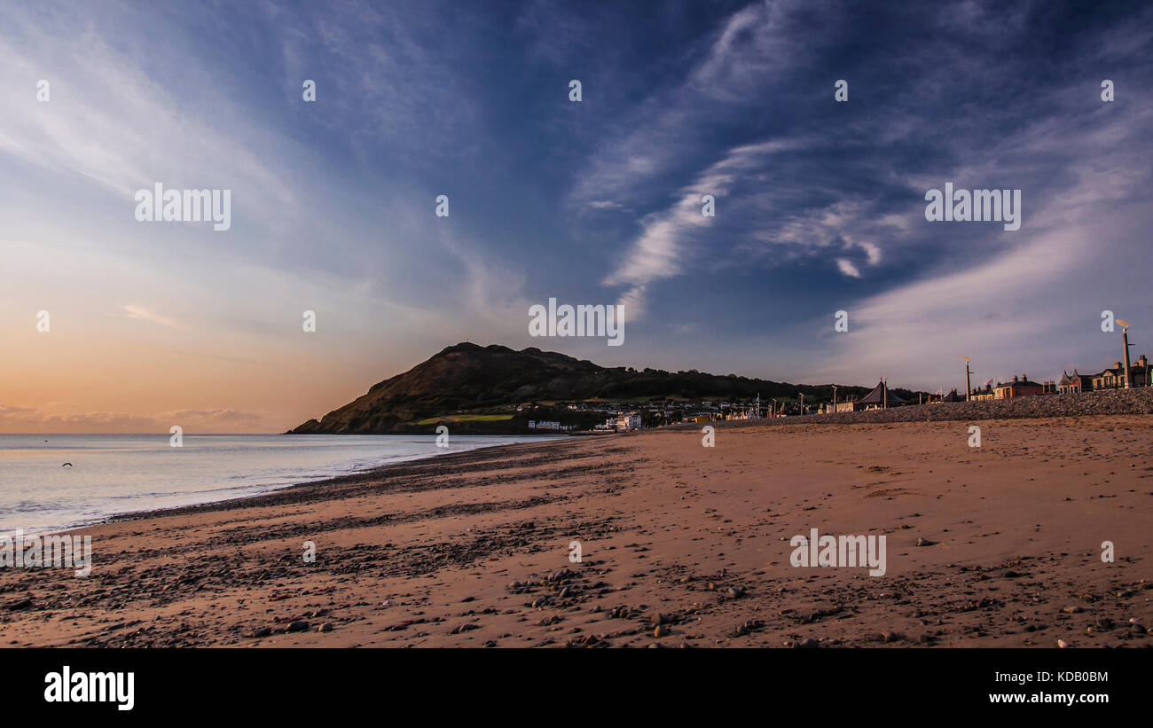 Sandy beach in the town with view to Bray Head hills and Cross Stock Photo