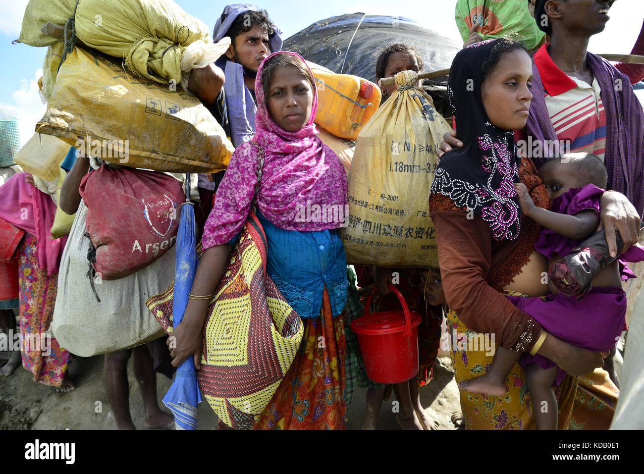 Hundreds of Rohingya people crossing Bangladesh's border as they flee from Buchidong at Myanmar after crossing the Nuf River in Taknuf, Bangladesh. Stock Photo
