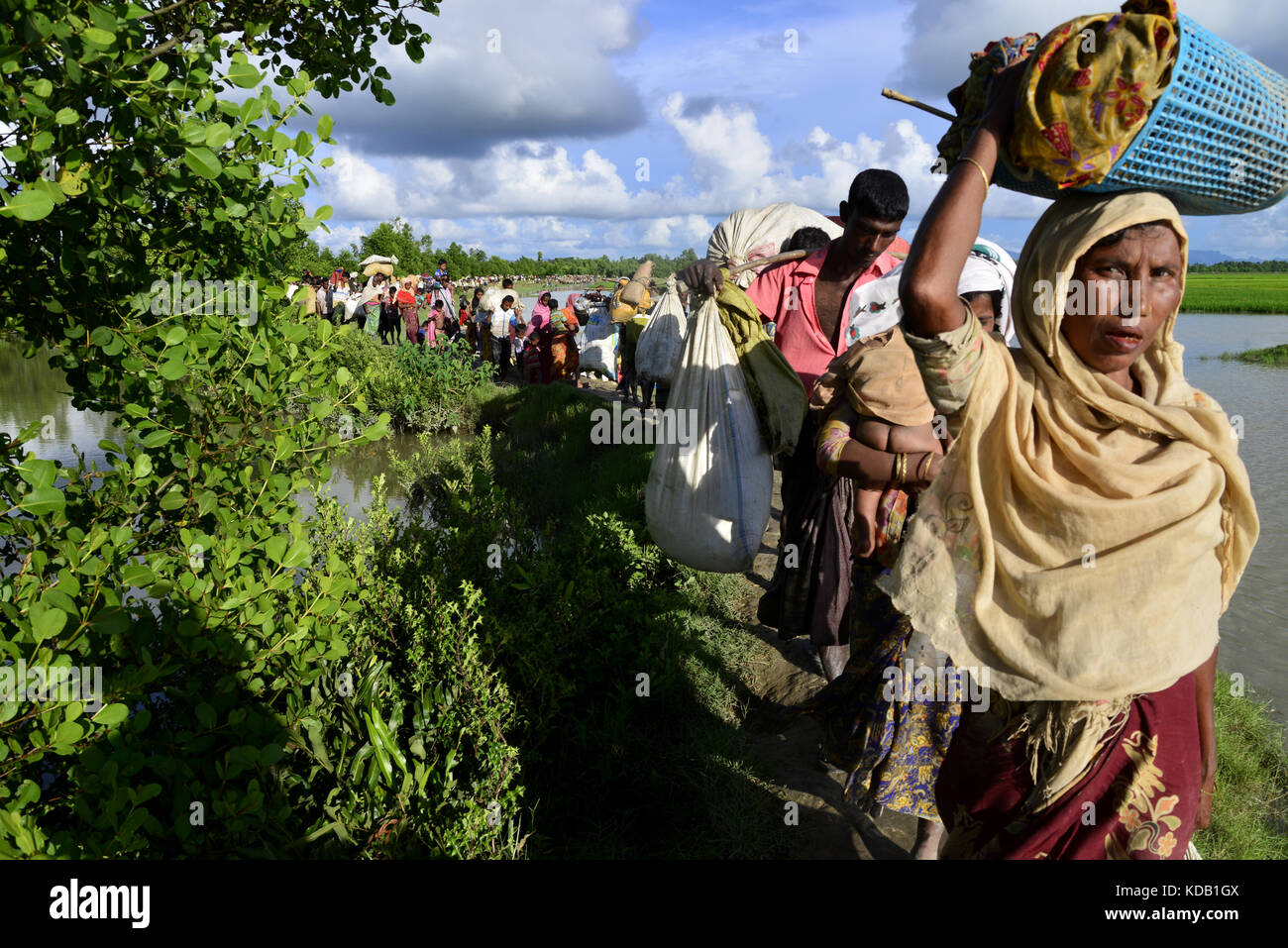 Hundreds of Rohingya people crossing Bangladesh's border as they flee from Buchidong at Myanmar after crossing the Nuf River in Taknuf, Bangladesh. Stock Photo