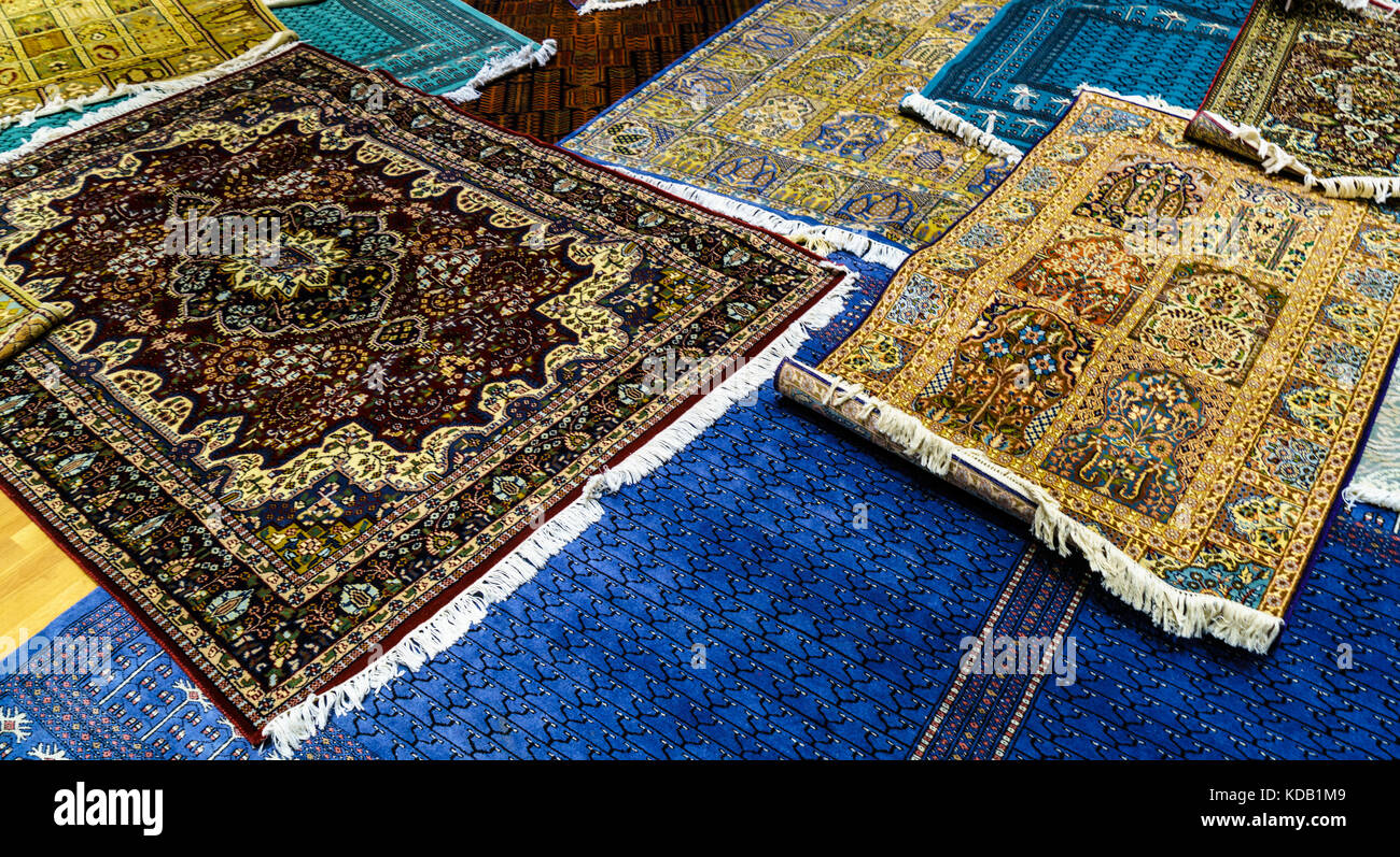 A collection of handmade rugs on display at a shop in Jaipur, India
