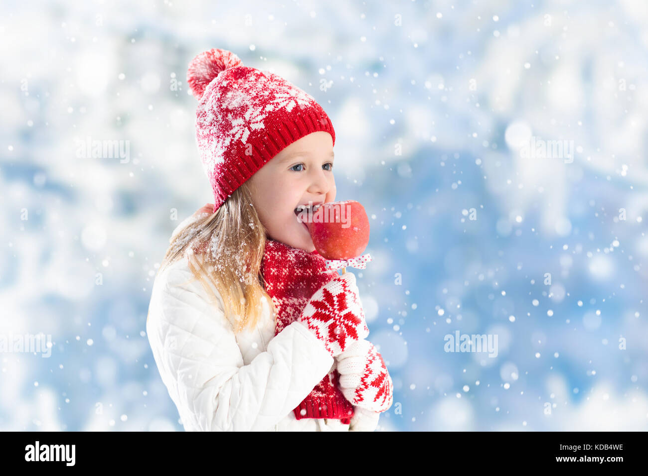 Child Eating Candy Apple On Winter Fair. Kids Eat Toffee Apples On 