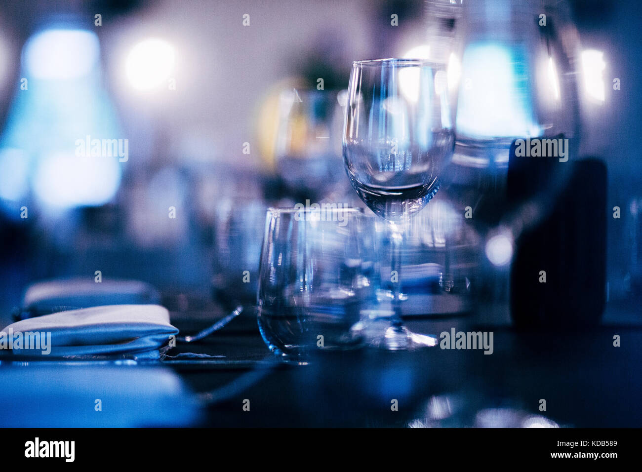 Luxury table settings for fine dining with and glassware, beautiful blurred  background. Preparation for holiday  Christmas and Hannukah dinner night. Stock Photo