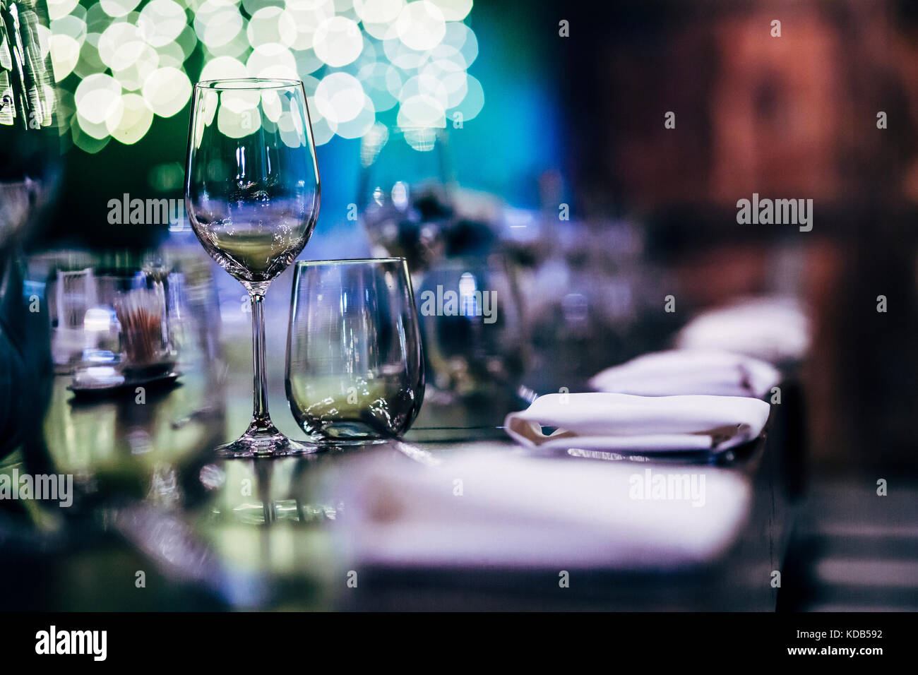 Luxury table settings for fine dining with and glassware, beautiful blurred  background. Preparation for holiday  Christmas and Hannukah dinner night. Stock Photo