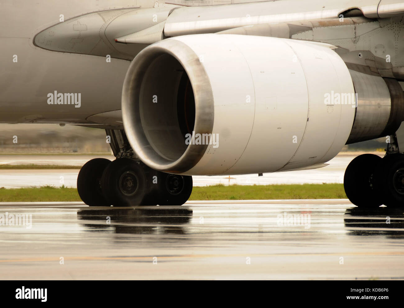 Large jet engine above a wet runway Stock Photo Alamy