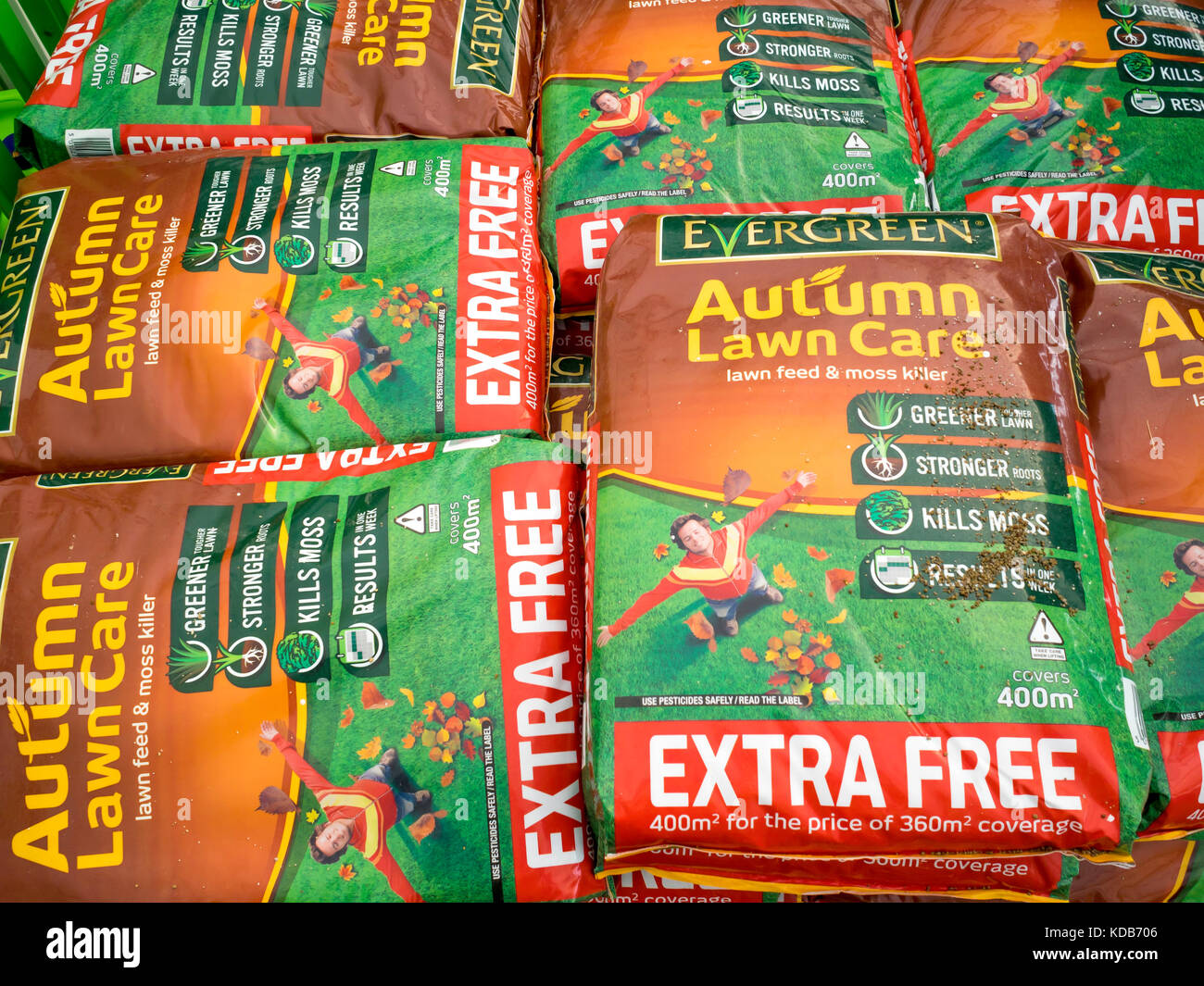 Stack of bags of Autumn Lawn feed and moss killer in a garden centre