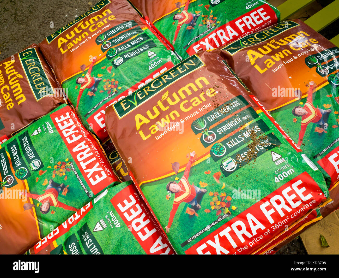 Stack of bags of Autumn Lawn feed and moss killer in a garden centre