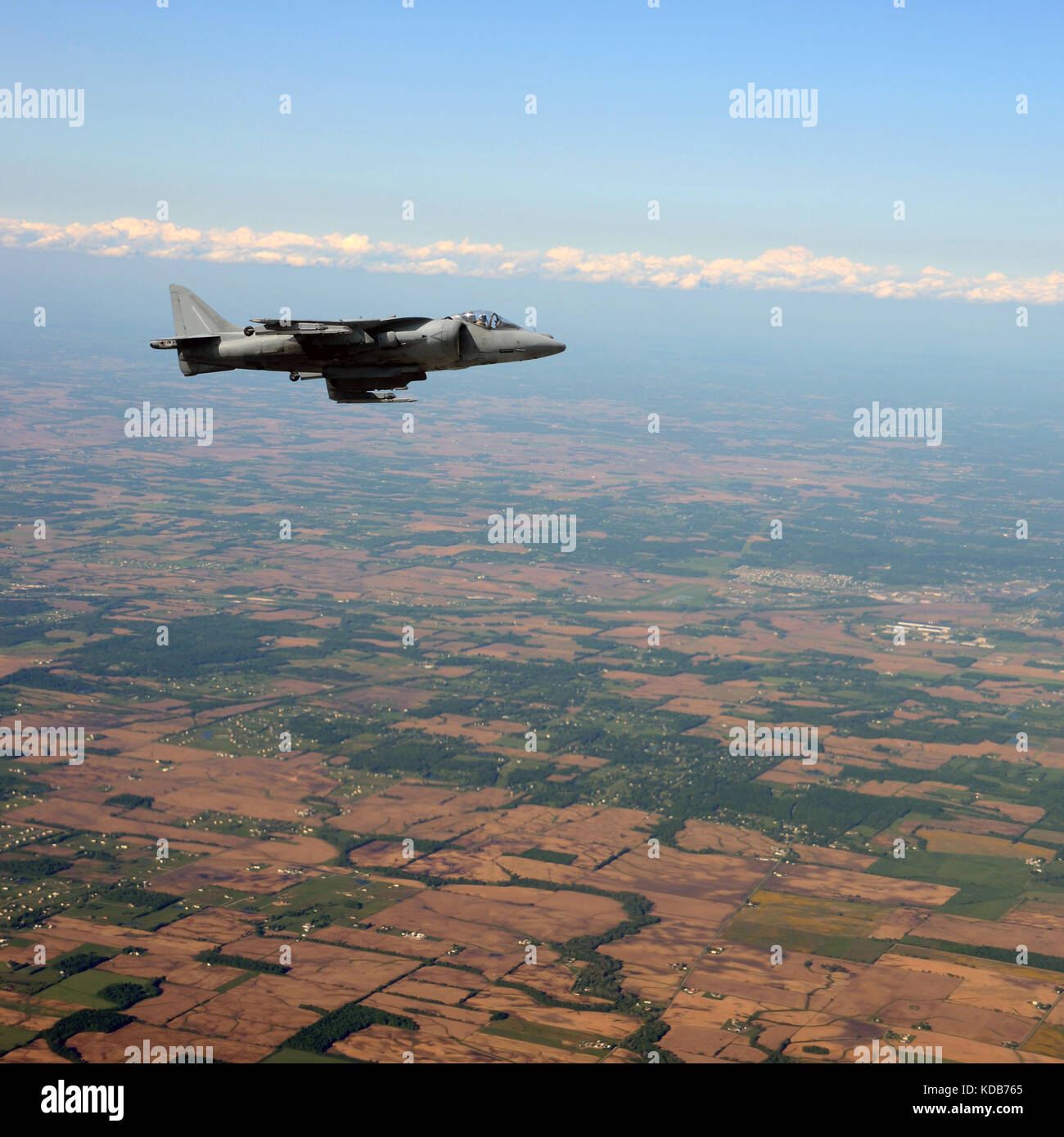 Jetfighter flying at high altitude above land Stock Photo - Alamy