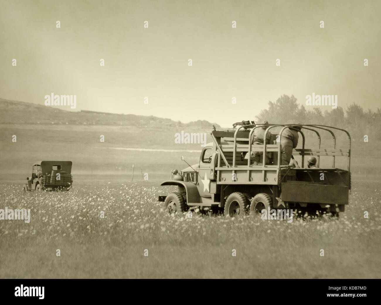 World War II era trucks and jeep in the countryside Stock Photo