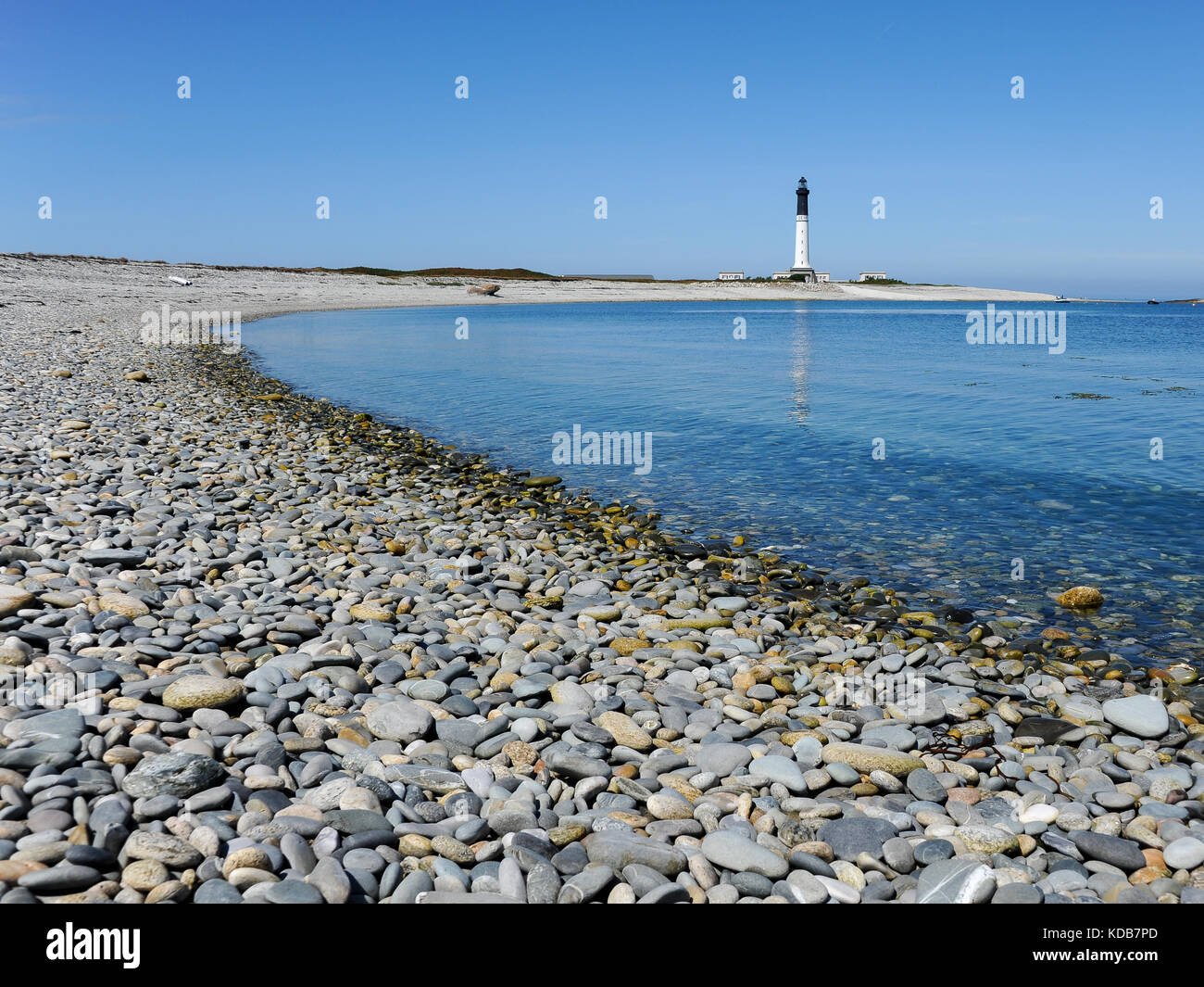 Gravel beach on Ile de Sein (France) with lighthouse in the background Stock Photo