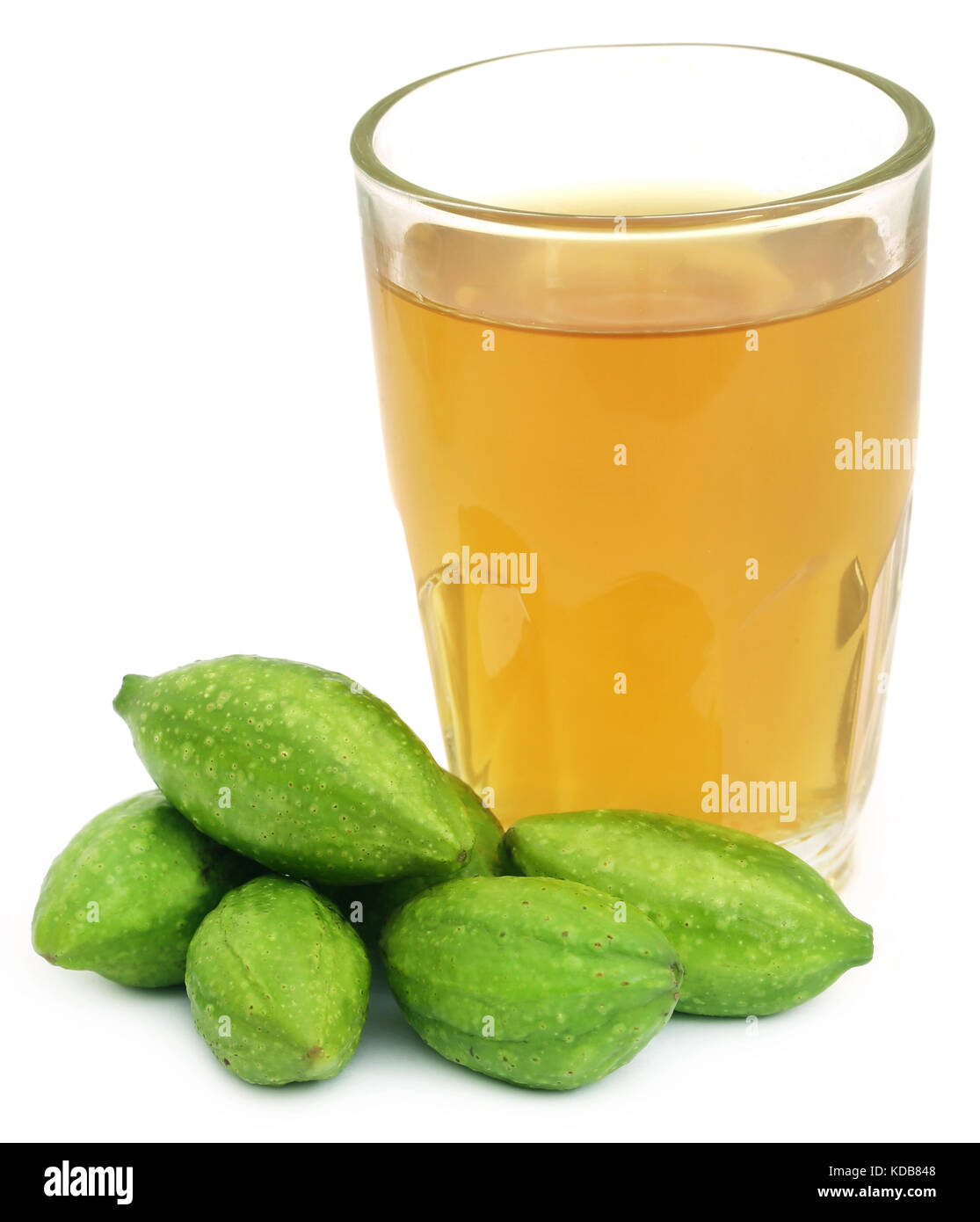 Fresh green medicinal haritaki fruits with extract in a glass Stock Photo