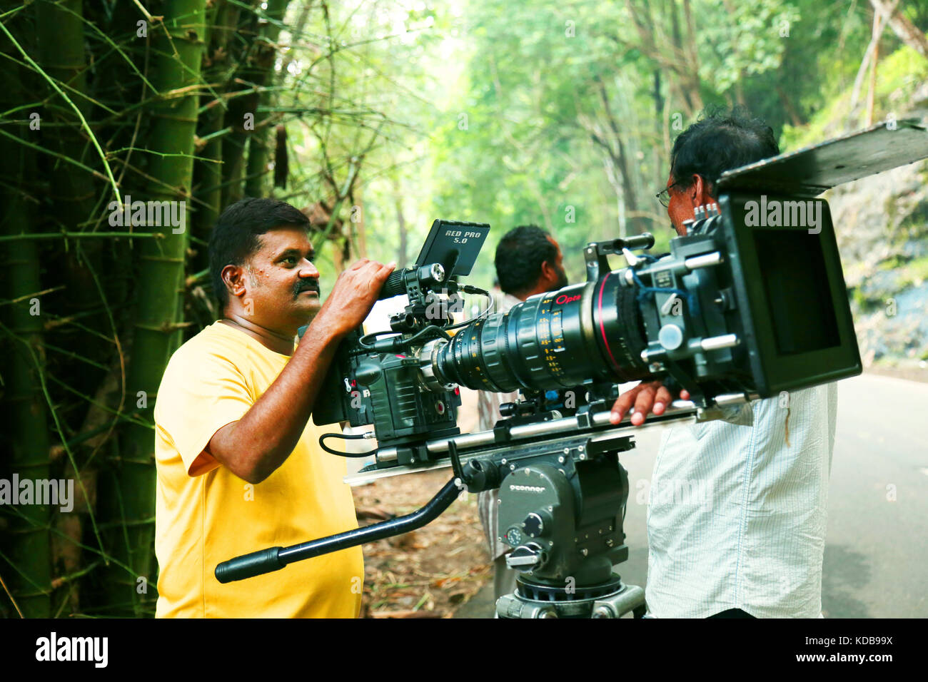 Video camera operator on nature background, film shooting spot Stock Photo