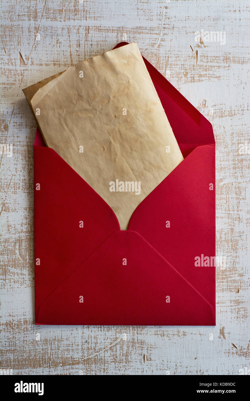 Red envelope, vintage letter, weathered white wood Stock Photo