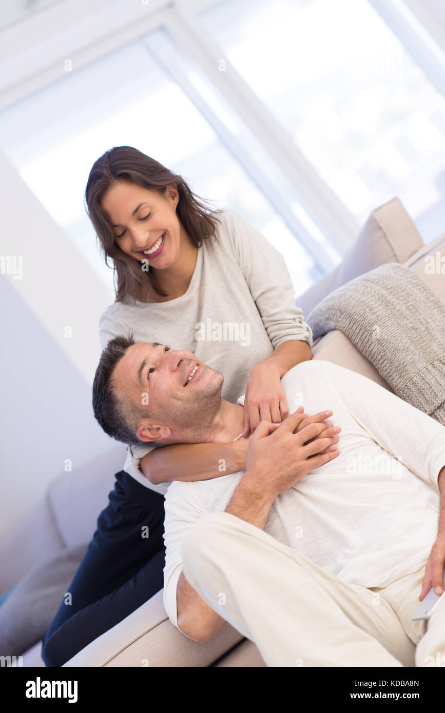 Portrait of a happy young beautiful couple hugging in their new home ...