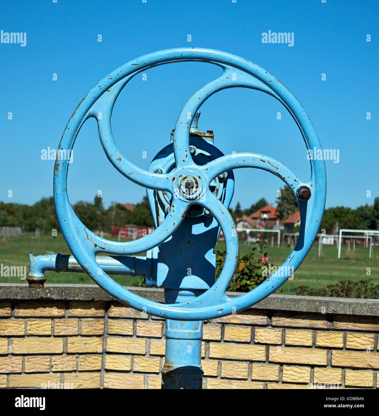 Blue wheel on water well pump, close up Stock Photo