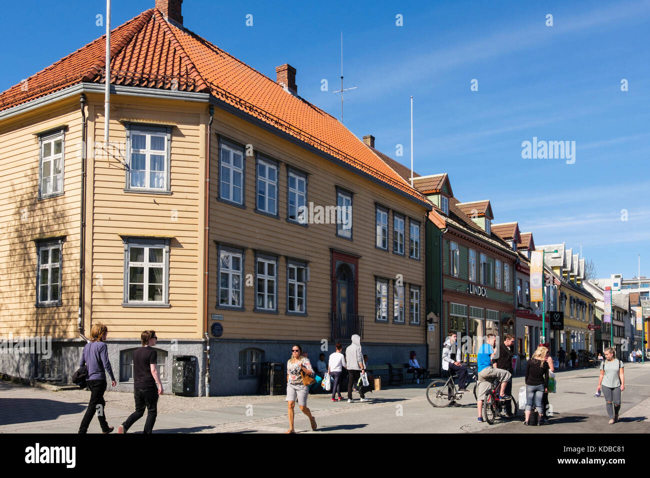 Street scene with people outside Bishops' House in traditional wooden building in old city centre in summer. Storgata, Tromso, Troms county, Norway Stock Photo