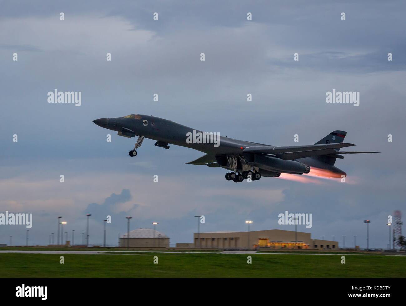 A U.S. Air Force B-1B Lancer bomber with the 37th Expeditionary Bomb Squadron takes off to join the Japan Air Self-Defense Force and South Korean Air Force in a joint night operation over the Sea of Japan October 10, 2017 in Guam. The mission marks the first time U.S. Pacific Command B-1B Lancers have conducted combined training with JASDF and ROKAF fighters at night. Stock Photo
