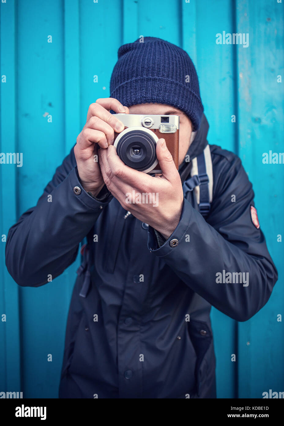 Man Taking A Photo With Instant Camera Stock Photo