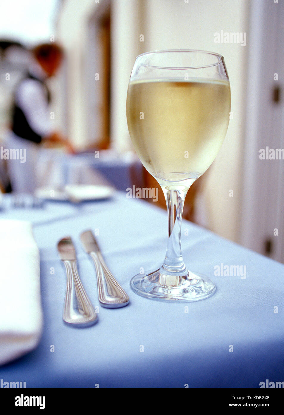Strill life. Food.  Restaurant interior table setting with glass of white wine. Stock Photo