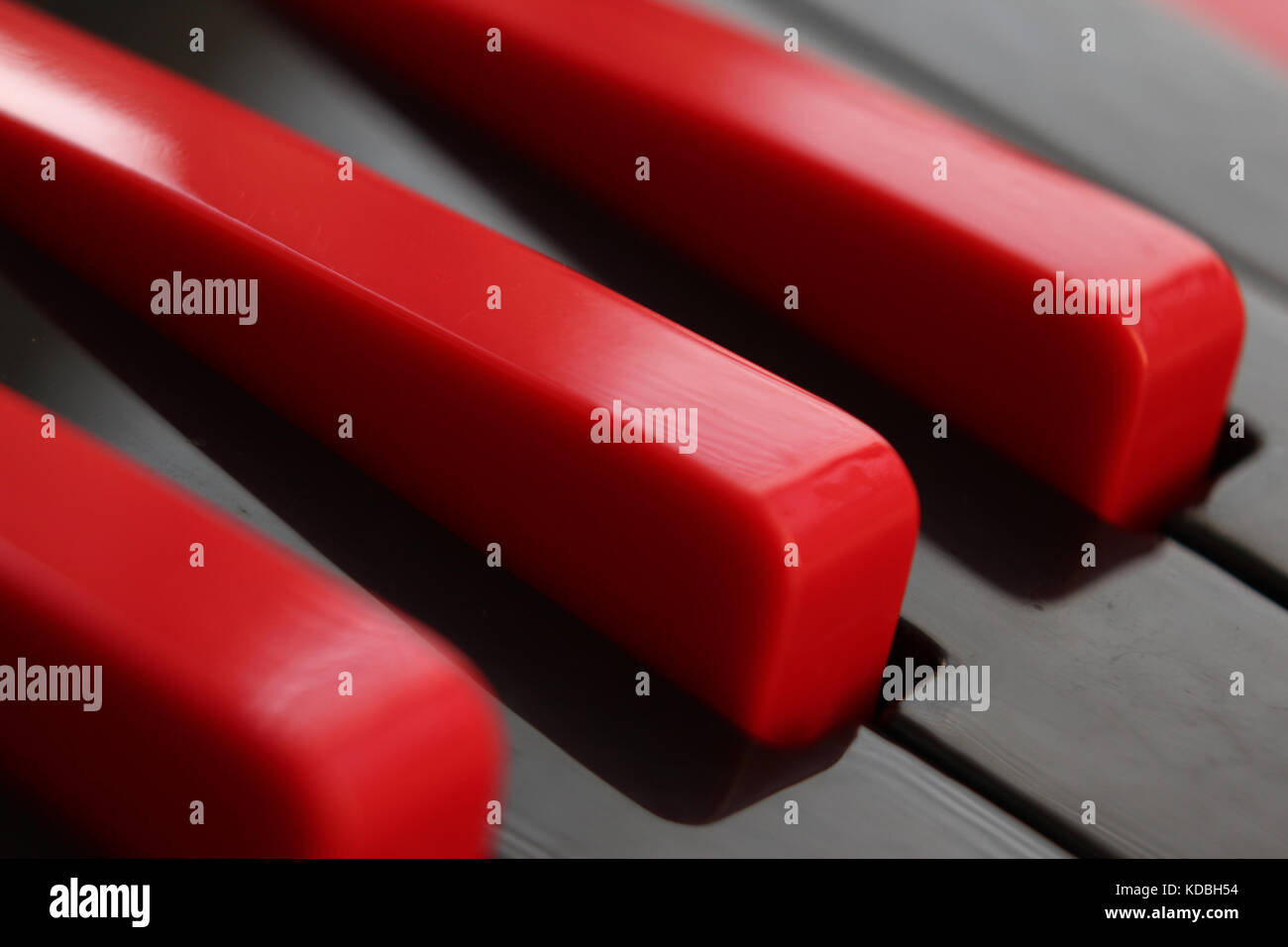 Closeup of black and red keys of plastic melodica keyboard. Stock Photo