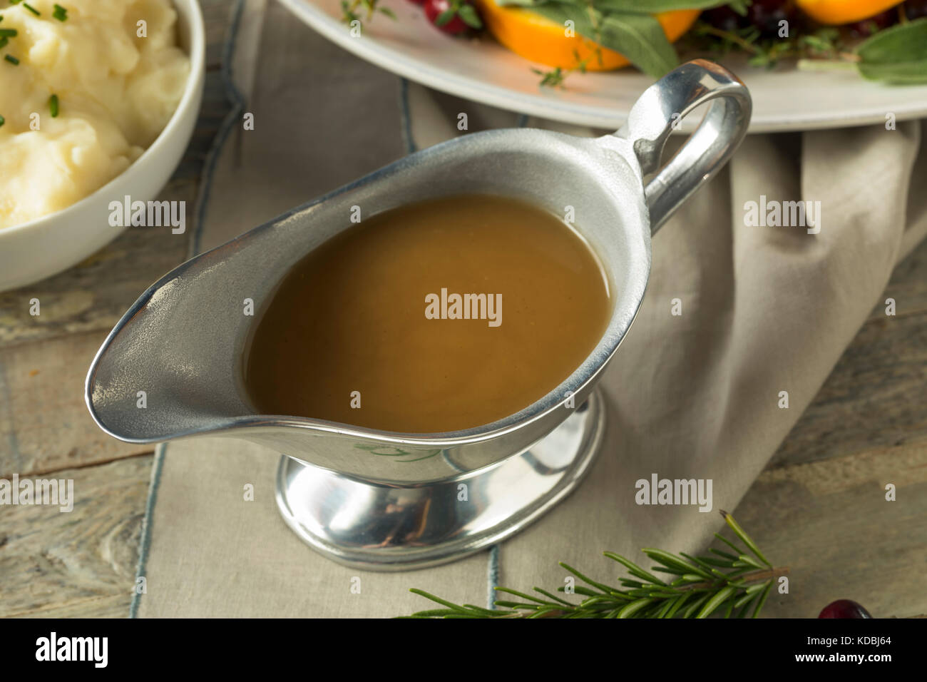 Hot Brown Organic Turkey Gravy in a Boat Stock Photo