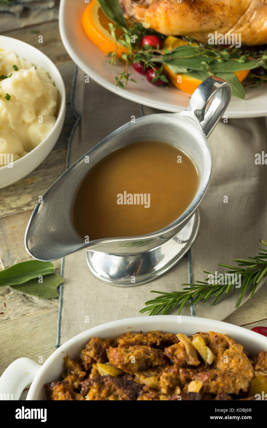 Hot Brown Organic Turkey Gravy in a Boat Stock Photo