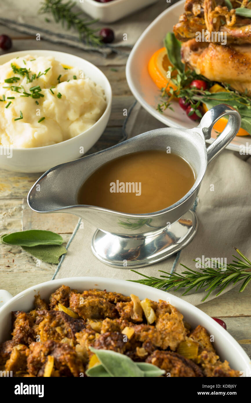 Hot Brown Organic Turkey Gravy in a Boat Stock Photo