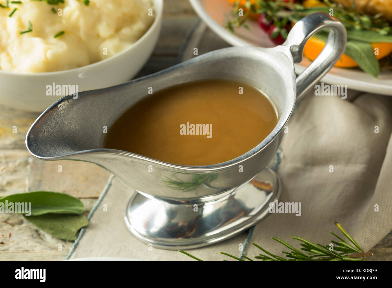 Hot Brown Organic Turkey Gravy in a Boat Stock Photo