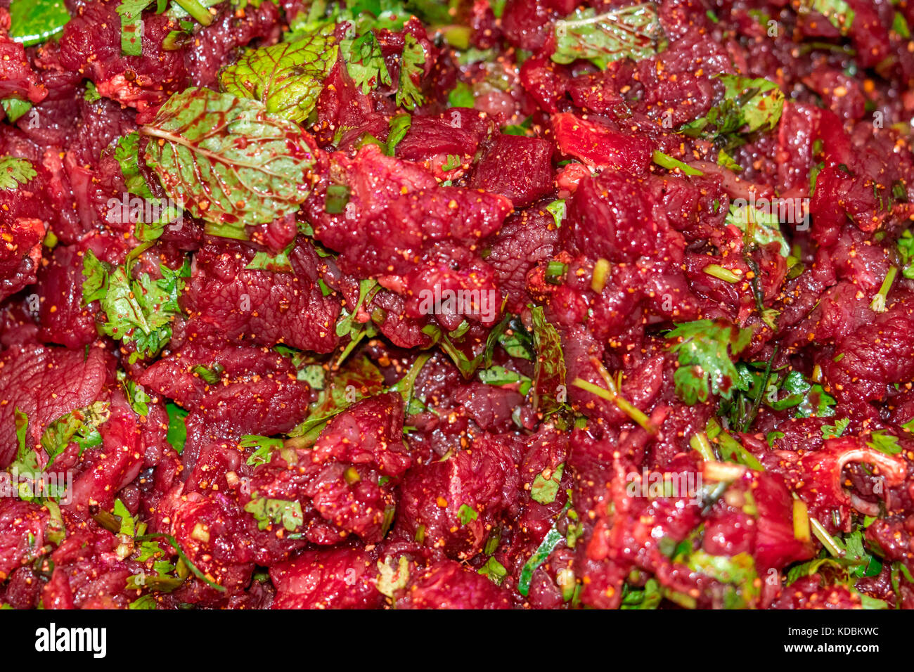 Raw spicy Thai minced beef salad, Northeast Thailand food culture. Cause of tapeworm Stock Photo