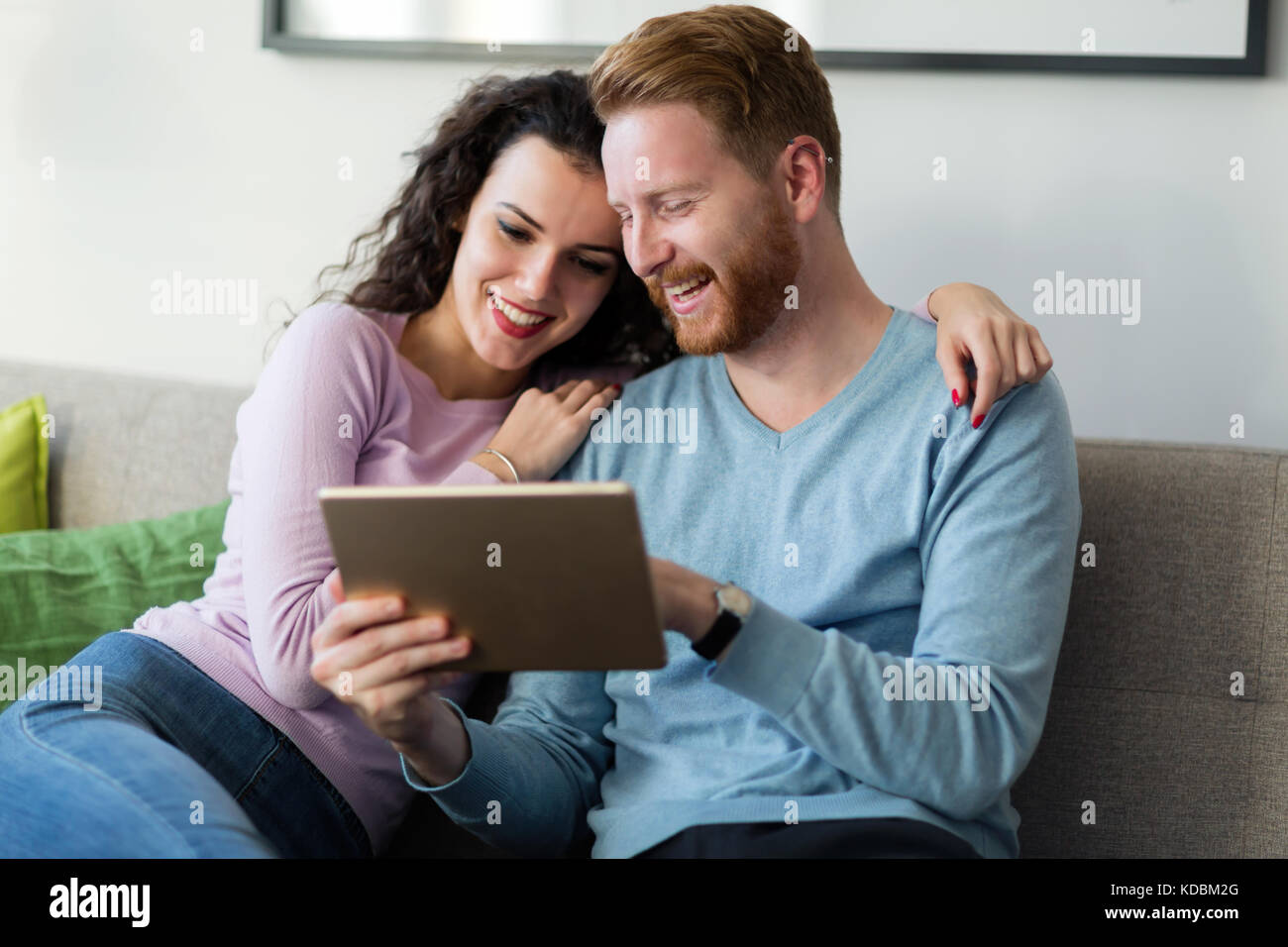Young couple using digital tablet at home Stock Photo