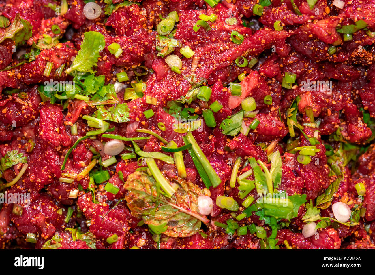 Raw spicy Thai minced beef salad, Northeast Thailand food culture. Cause of tapeworm Stock Photo