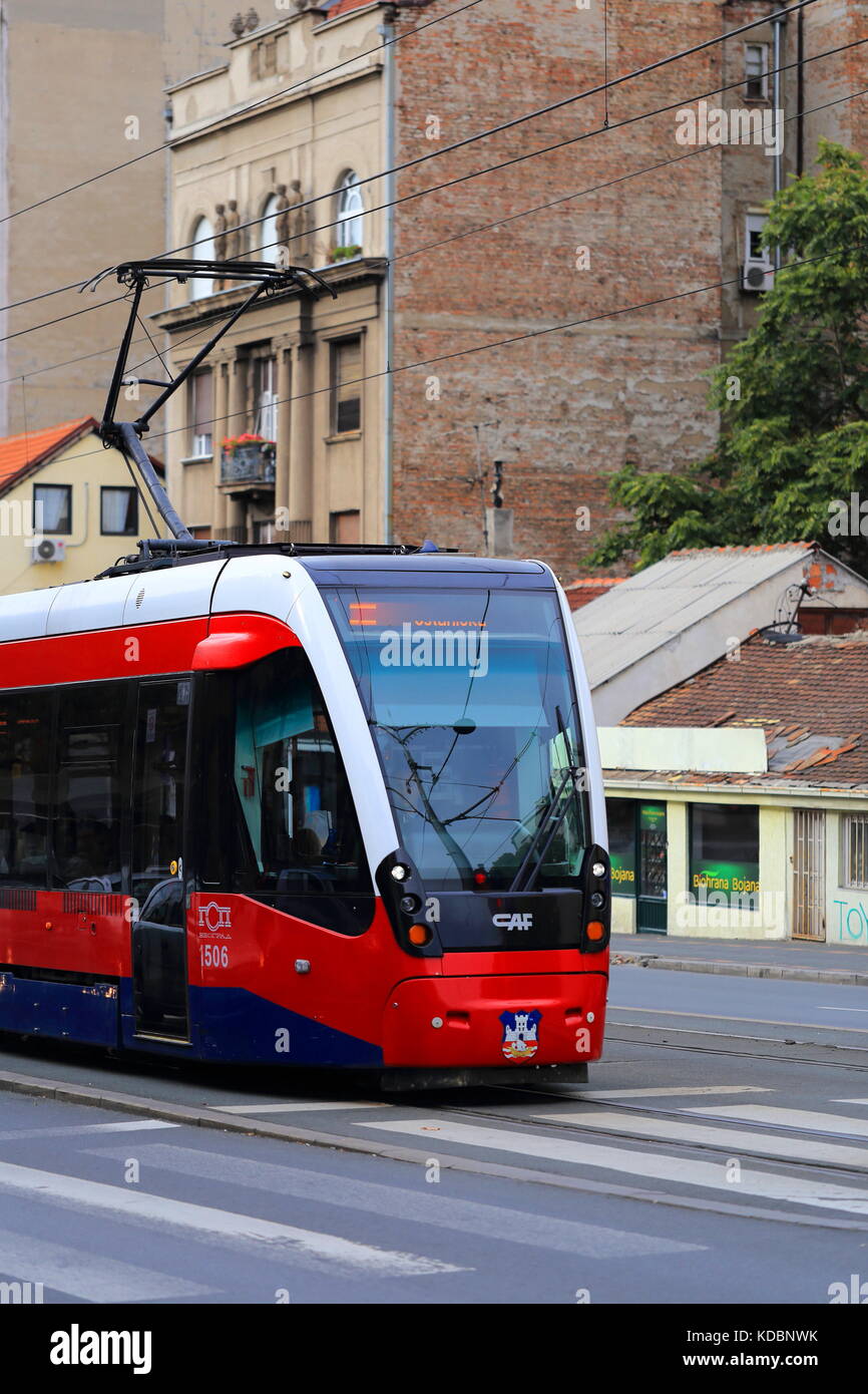 New red CAF Urbos 3 tram on the streets of Belgrade, Serbia Stock Photo