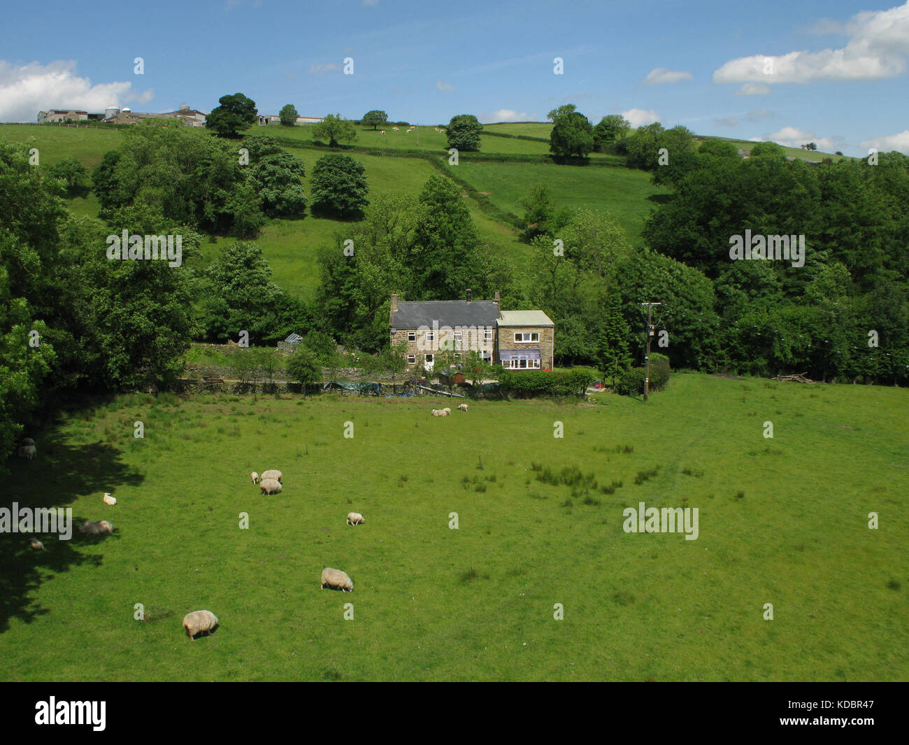 Elevated view of small derbyshire farm with fields to foreground Stock