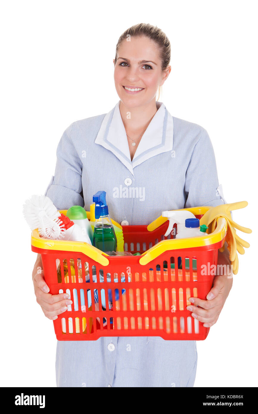 Female Cleaner Holding Detergent And Chemical Supplies In Basket Over White Background Stock Photo