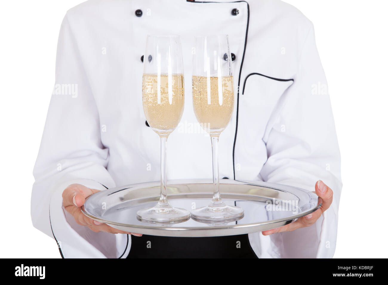 Portrait Of Female Chef Holding Champagne Over White Background Stock Photo