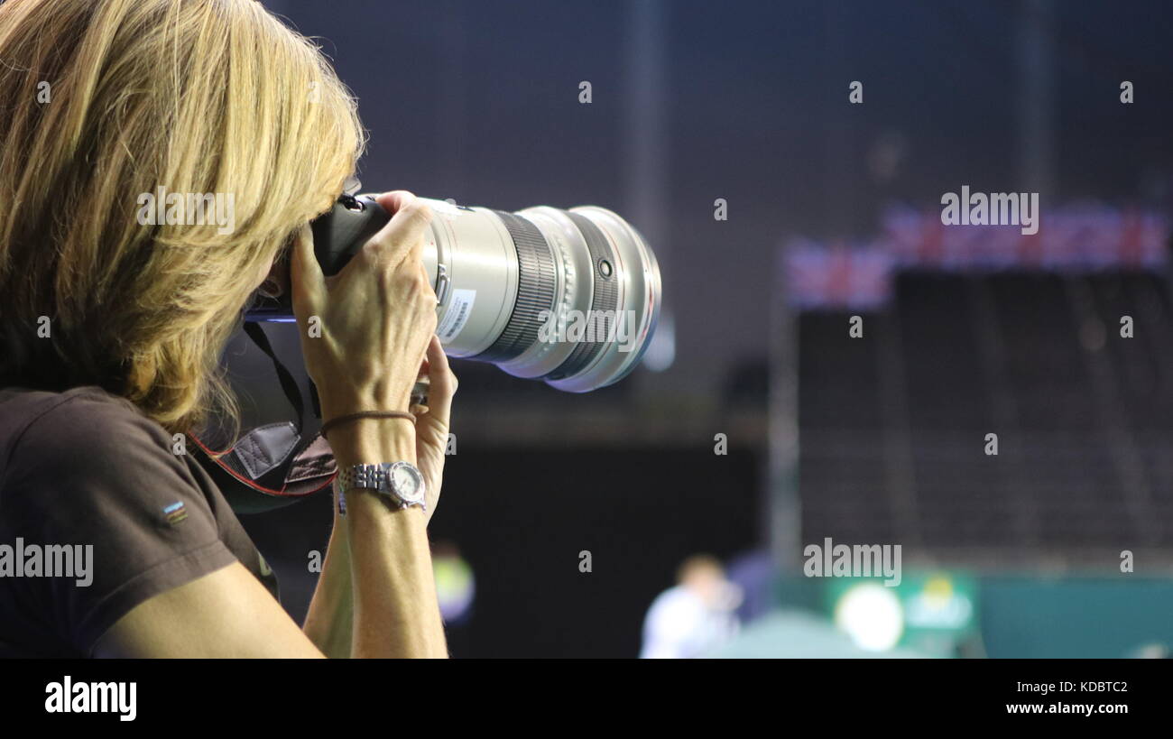 female photographer holding camera with long lens Stock Photo Alamy