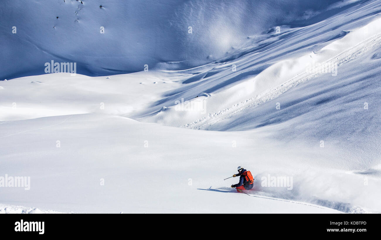 Extreme skier going through steep slope Stock Photo
