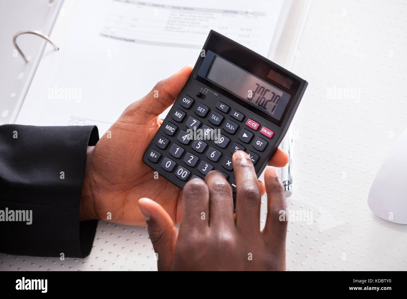 Close-up Of Businessman Calculating Finance At Office Stock Photo
