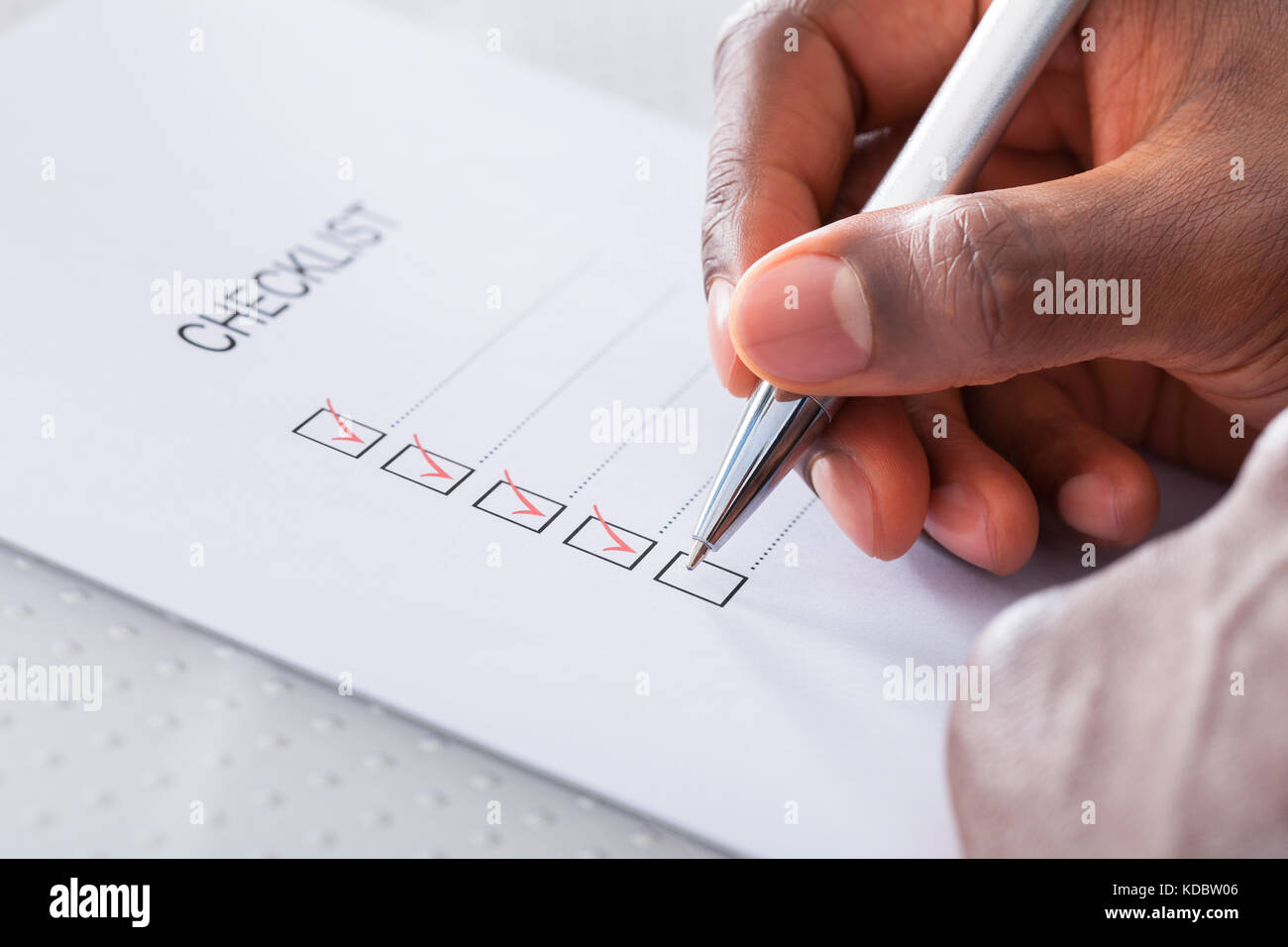 Close-up Of Hand With Red Pen Marking A Check Box Stock Photo