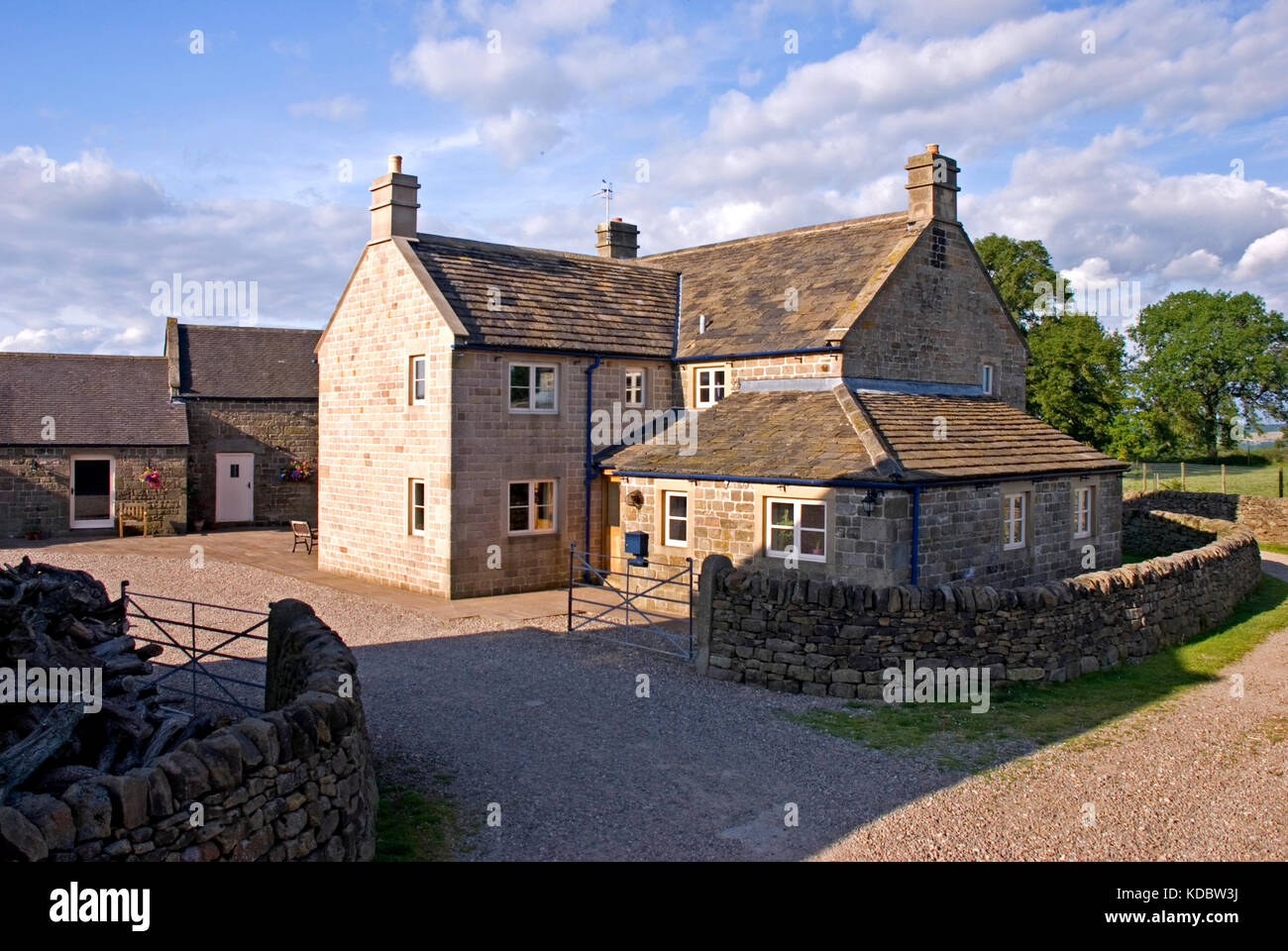 Large Derbyshire stone farmhouse with sunny skies Stock Photo