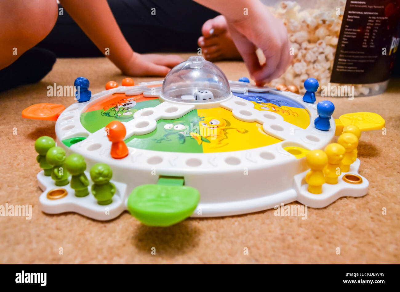 A family evening at home playing a game of Frustration, a classic children's board game. Stock Photo