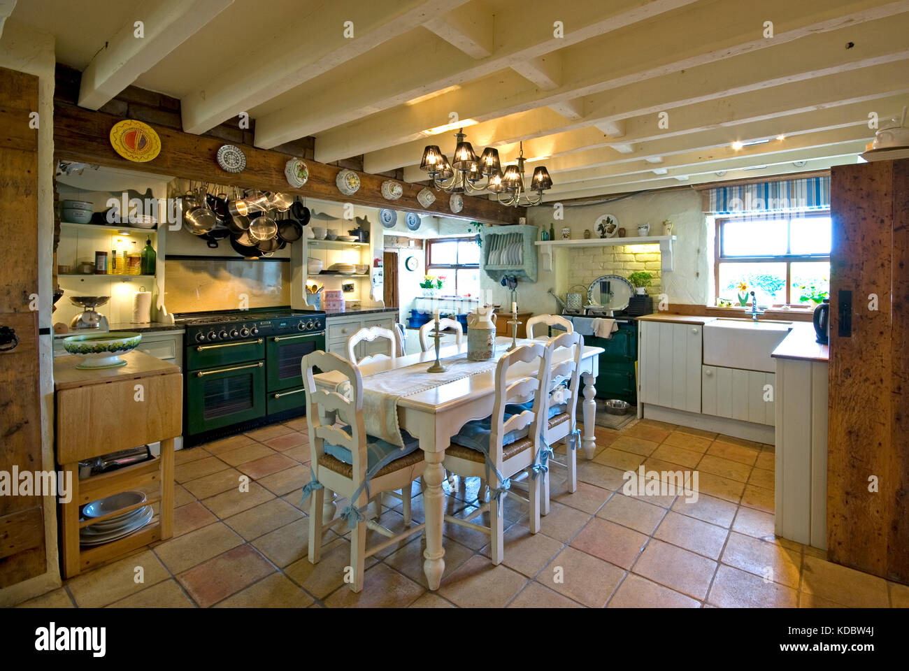 Farmhouse dining kitchen with green range cooker Stock Photo