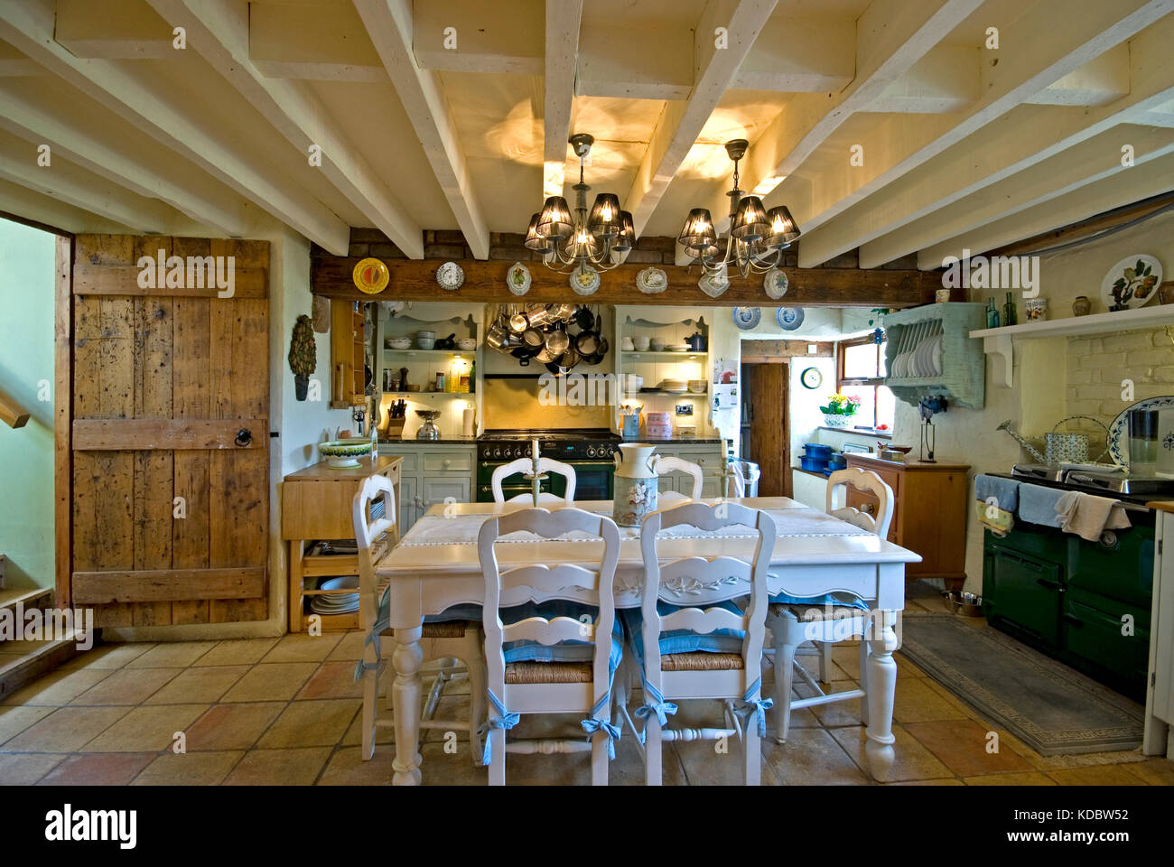 Farmhouse kitchen diner with white table and exposed beams Stock Photo