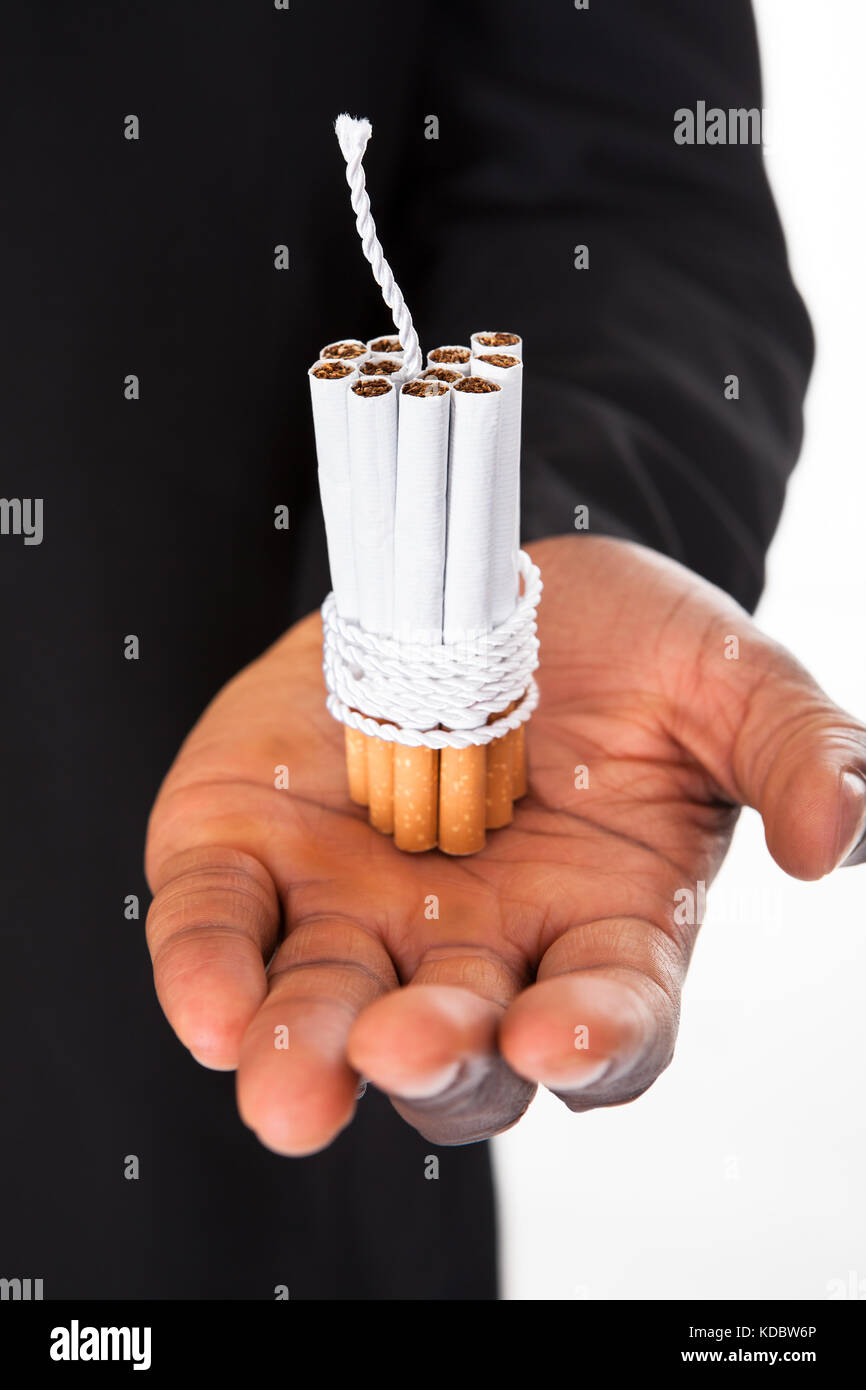 Close-up Of Human Hands Holding Cigarettes Tied With Rope And Wick Stock Photo