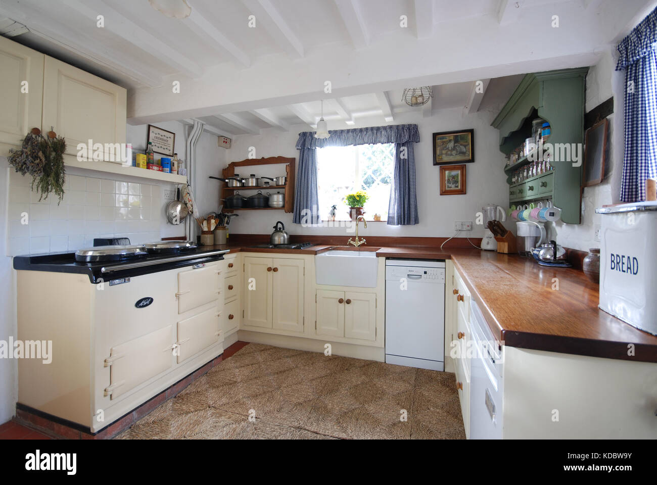 Farmhouse Kitchen With Cream Range And Wooden Worktops Stock Photo