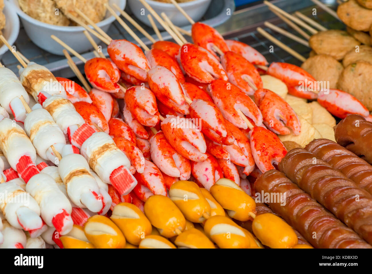 food on the streets of asia crab claws and grilled sausages closeup